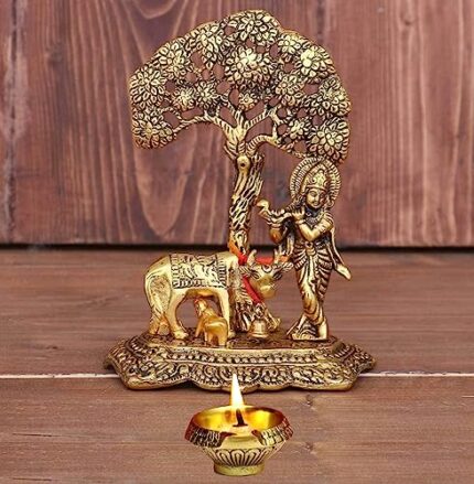 Efinito Metal Krishna with Cow Standing Under Tree Plying Flute with Kuber Diya Decorative Showpiece (Metal, Gold)